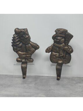 2 Vintage Christmas Shoppe Stocking Holder brown cast iron Santa w/ Tree Snowman